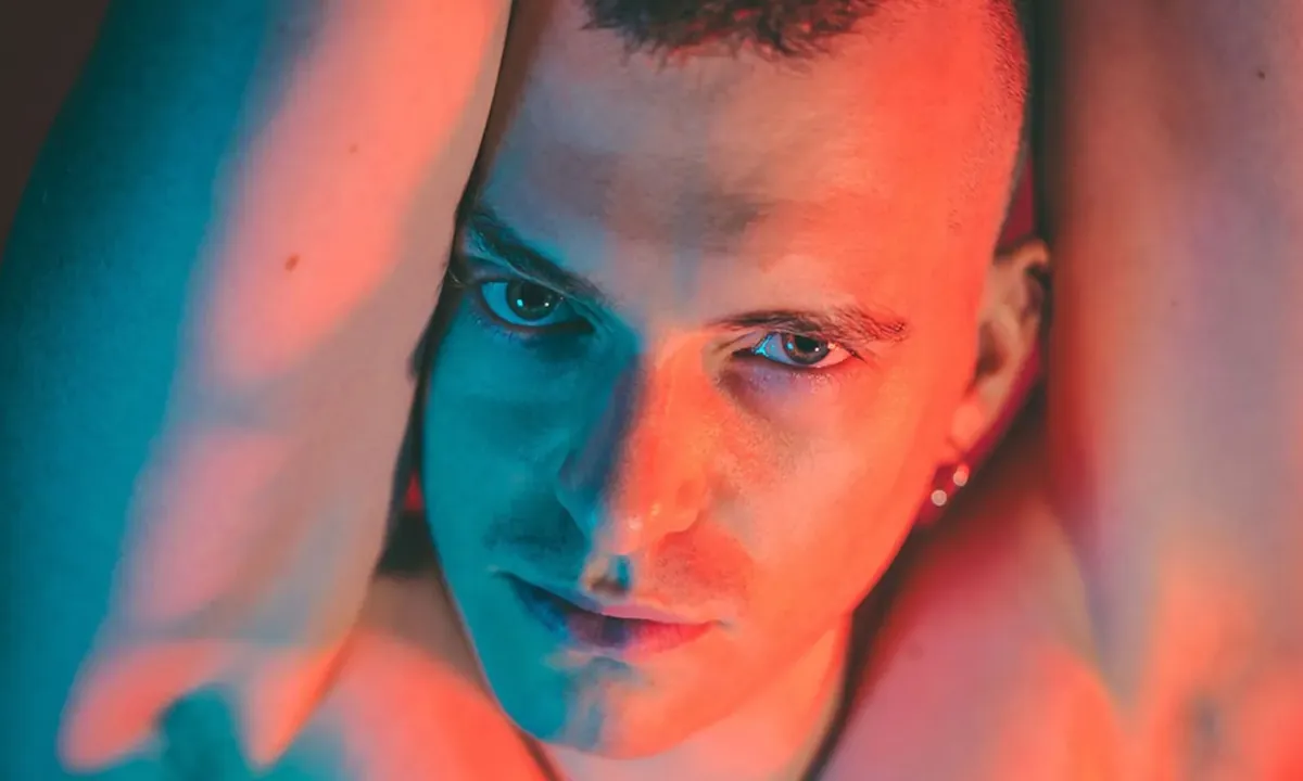 Axel Abysse neon-lit studio portrait
