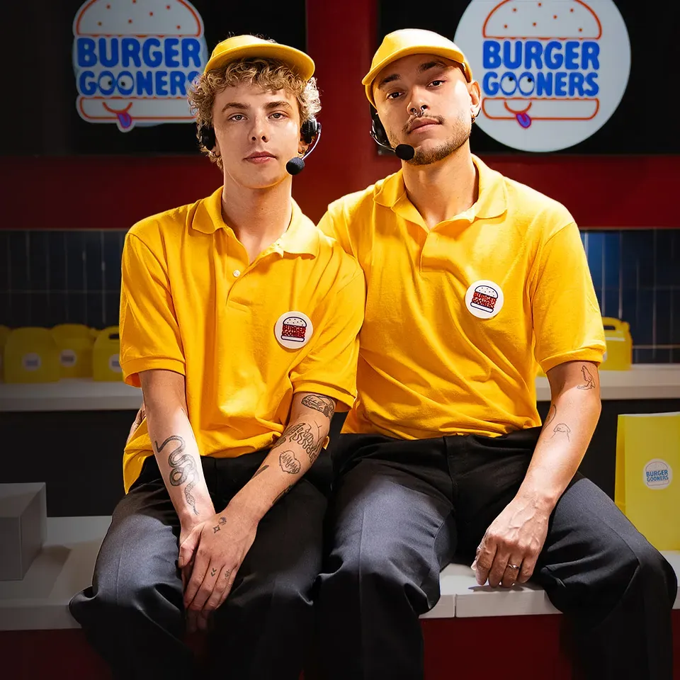 MEN key art: two performers in fast-food uniforms