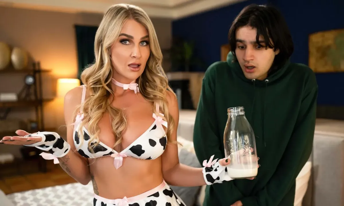 MILFED scene still: a performer in a cow-print outfit holding a milk bottle